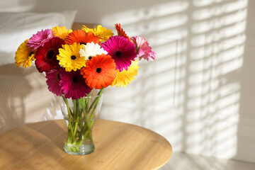 Bouquet of beautiful gerbera flowers on table indoors. Space for text