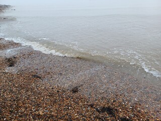 The sea and a shingle beach with the tide coming in waves