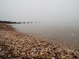 The sea and a shingle beach with the tide coming in waves