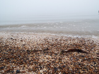 The sea and a shingle beach with the tide coming in waves