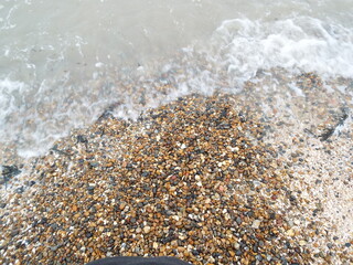The sea and a shingle beach with the tide coming in waves