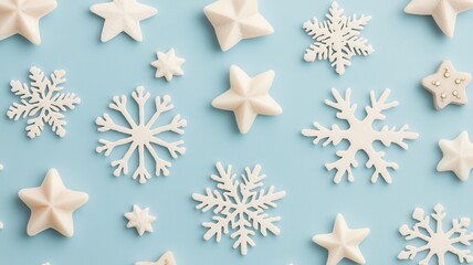 A collection of white snowflakes and stars arranged on a light blue background, creating a festive and winter-themed aesthetic.