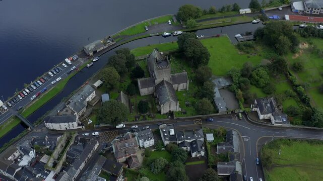 St Flannan's Cathedral, Killaloe, County Clare, Ireland, September 2021. Drone orbits counter clockwise at a high angle showcasing the Church and pulling back to reveal the River Shannon.