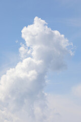 vertically developing cumulonimbus cloud rising high into the blue sky