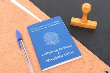 Signing the Brazilian work card. Translation: Federative Republic of Brazil, Ministry of Labor.| Brazilian Work Card (Carteira de Trabalho). Formal job concept.