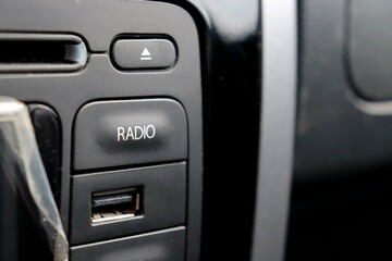 Car radio close up. Car panel. Radio button. 
