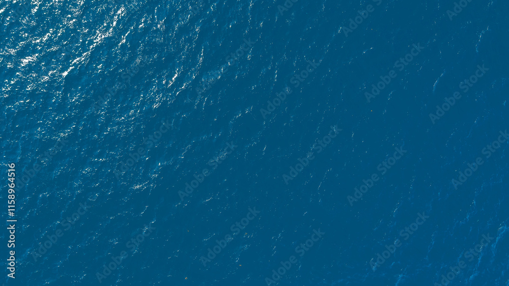 Poster Flat lay top view of Ocean blue and calm with sun rays reflection on smooth waves as textured blue background for banner template or web page design. Water calm with smooth waves.