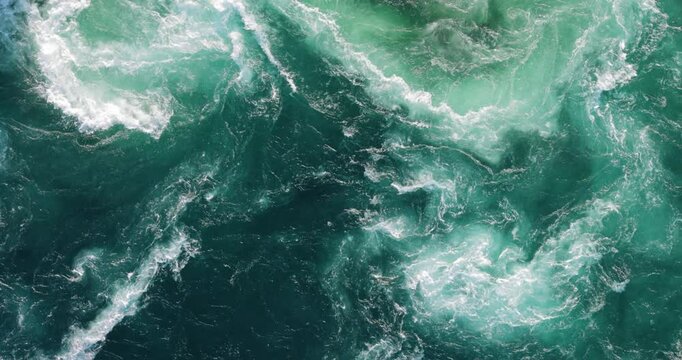 Blue waves of water of the river and the sea meet each other during high tide and low tide.