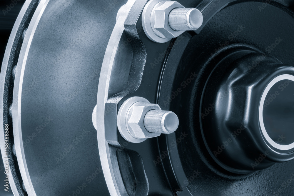 Poster the wheel is black and silver with a white rim and is secured with large bolts and nuts like part of