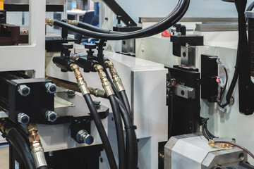 Part of industrial conveyor with hydraulic, pneumatic and electric drives, industrial concept background