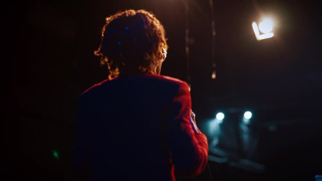 African american man performing on stage of theater or bar in night, comedy show . Stand-up comedy performance, entertainment and leisure in nightclub, person speaking funny jokes and motivation speak