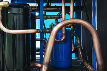 Close-up of refrigeration and compressor equipment. Tanks and copper connecting tubes
