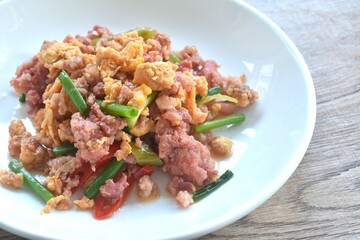 spicy fried chop fermenting sour pork with egg and spring onion on plate