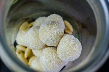 Homemade raw vegan coconut truffles - coconut balls aka Raffaello in the glass jar
