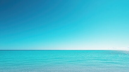 Fototapeta premium Ocean view under expansive clear blue sky with vibrant hue