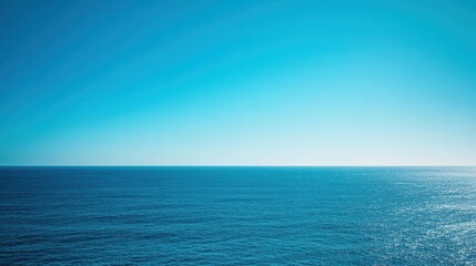 Fototapeta premium Ocean view under vast clear blue sky with gradient towards horizon