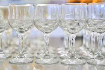 A row of empty, clear, clean wine glasses. Close-up with space to copy. High quality photo