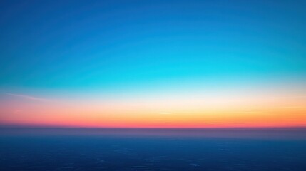 Fototapeta premium Expansive clear blue sky with golden sunrise and unobstructed horizon