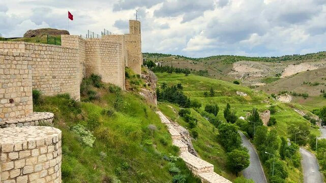 Harput fortress with the Turkish flag, in the spring in Eastern Anatolia, Elazig, Turkey. Harput Castle or Harberd, also known as Sut Kalesi. Ancient city. 4К
