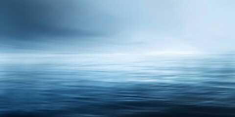 Obraz premium A blue ocean with a cloudy sky in the background