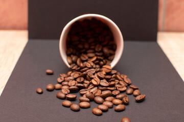 Paper cup and roasted coffee beans