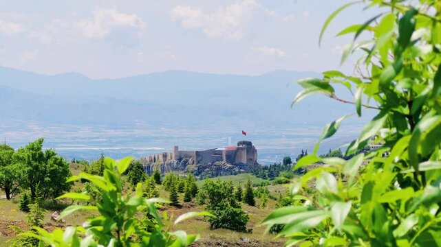 Harput fortress with the Turkish flag, in the spring in Eastern Anatolia, Elazig, Turkey. Harput Castle or Harberd, also known as Sut Kalesi. Ancient city. 4К