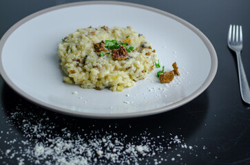 Mushroom risotto on a white plate, top view and close-up