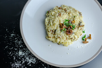 Mushroom risotto on a white plate, top view and close-up