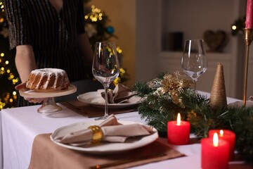 Woman setting table for dinner at home, closeup