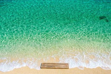 Obraz premium A scenic Ibiza beach featuring a wooden pier stretching out into the clear, turquoise sea