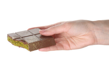 Woman holding piece of Dubai chocolate bar with pistachio and knafeh on white background, closeup