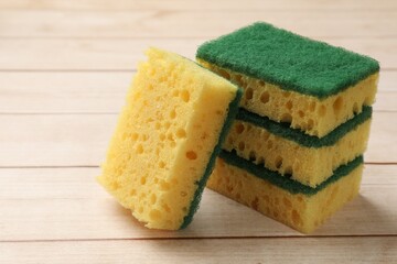 Many soft sponges on wooden table, closeup
