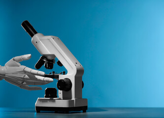 Artificial intelligence. Robot hand working with microscope at grey table against blue background, space for text