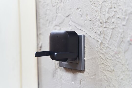 Black wifi signal booster on white background, top view. Wifi connection. Wifi transmitter, router.