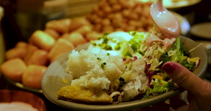 buffet pour sauce on salad Korean cheese toppoki and Chinese oil dry noodles served with deep-fried chicken