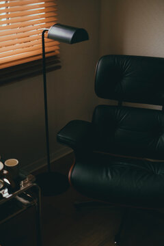 Eames Loung chair Ottoman by Vitra in home interior, floor lamp and coffee table. Mid century interior room. Marl, Germany. December 22 2024	