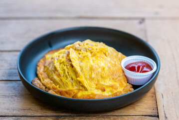 Omelet fried beaten eggs with chilli sauce,Thai traditional style eggs dish.