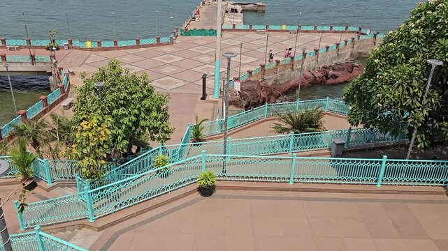 Goa , India 28th April 2024 Dona Paula viewpoint . The view captures boats in the distance, emphasizing Goa's coastal charm A beautifully designed pathway.