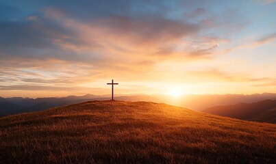 Obraz premium A serene landscape with a solitary cross on a hilltop at sunset, symbolizing peace and reflection. The warm hues of the sky provide a tranquil and spiritual ambience.