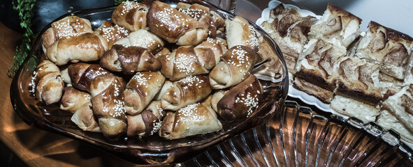 A background of patties in a dish; light brown and yellow tones, delicious food with coffee.