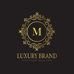 Letter M Luxury brand logo design with a royal gold crown emblem and elegant typography
