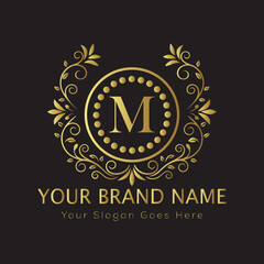 Letter M Luxury brand logo design with a royal gold crown emblem and elegant typography
