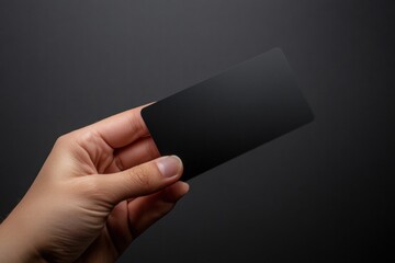 Sleek black gift card held in hand with empty space for custom text on dark background. Generative AI