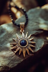 Fototapeta premium A necklace with a blue stone lying on a rock, great for use in jewelry or decorative scenes