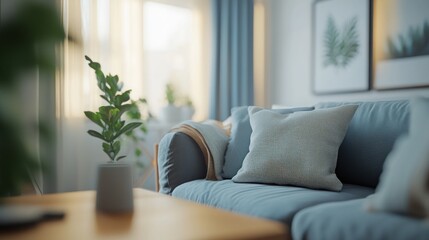 Fototapeta premium Cozy living room with blue sofa, plants, and natural light.