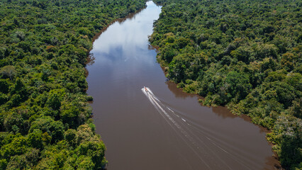 AERIAL PHOTOS OF THE NANAY RIVER AND BOATS NAVIGATING IN ITS WATERS, IN THE PERUVIAN AMAZON JUNGLE, BLACK WATER IGAPO WITH COMMUNITIES OF PEOPLE SURROUNDING THE NANAY.