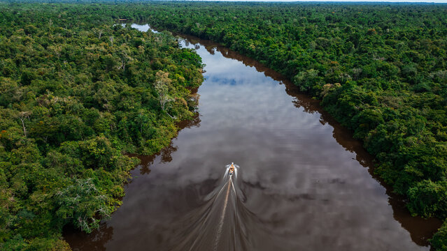 AERIAL PHOTOS OF THE NANAY RIVER AND BOATS NAVIGATING IN ITS WATERS, IN THE PERUVIAN AMAZON JUNGLE, BLACK WATER IGAPO WITH COMMUNITIES OF PEOPLE SURROUNDING THE NANAY.
