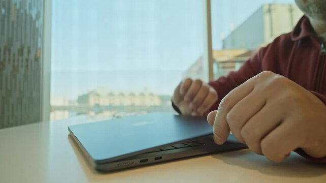 A Freelancer Developer Focuses On Typing Program Code On His Laptop. In A Coworking Office, The Environment Promotes Creativity, Innovation, And Productive Work Sessions.