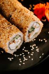 Fresh sushi with sesame and ginger on a black background. Sushi concept