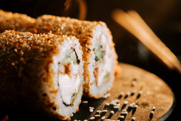 Fresh sushi with sesame and ginger on a black background. Sushi concept